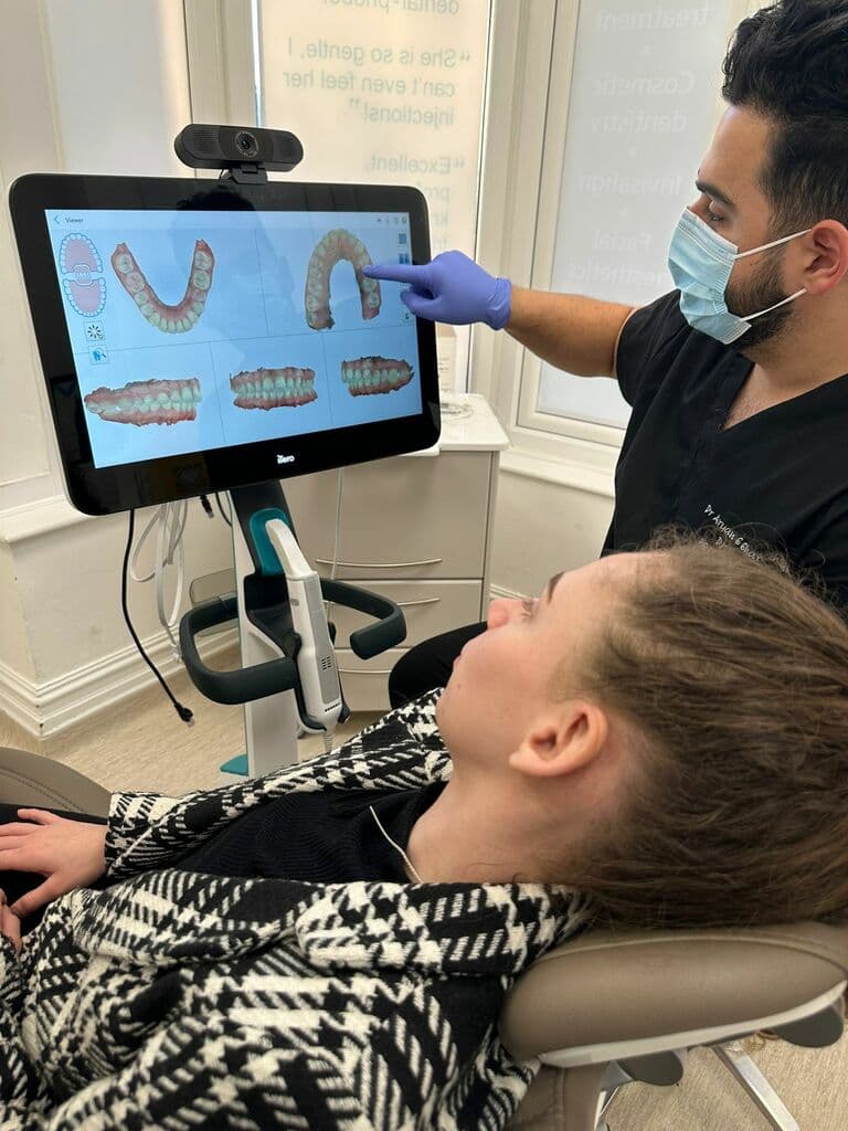 A patient having a 3D digital scan of their teeth at the clinic