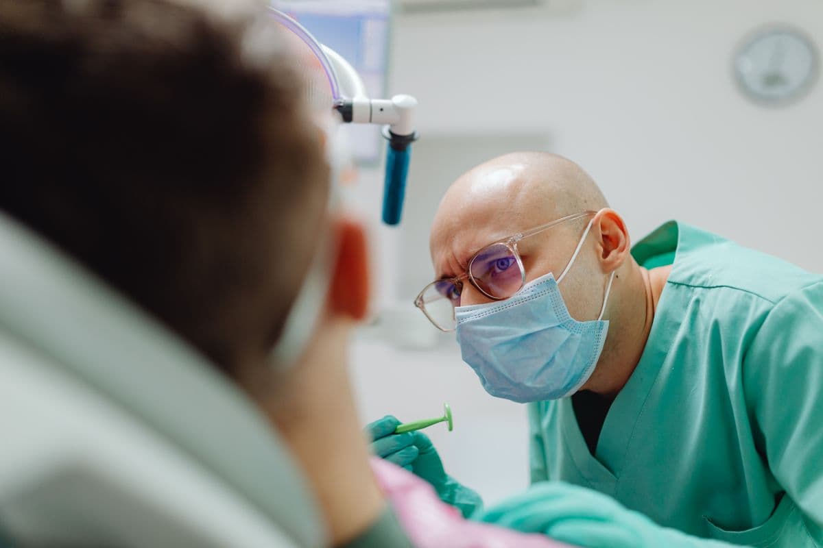 Dentist carefully applying composite bonding to a patient's tooth