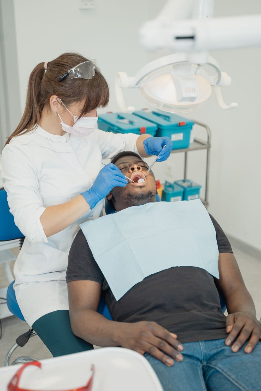 Dentist carefully treating a patient in the dental chair