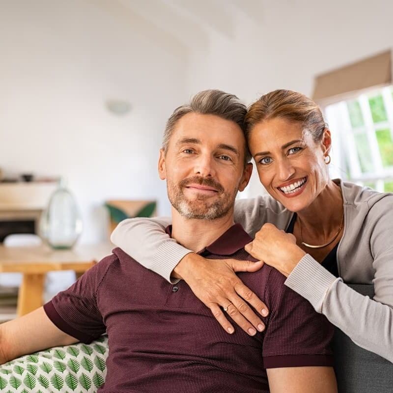 Couple with dental implants smiling