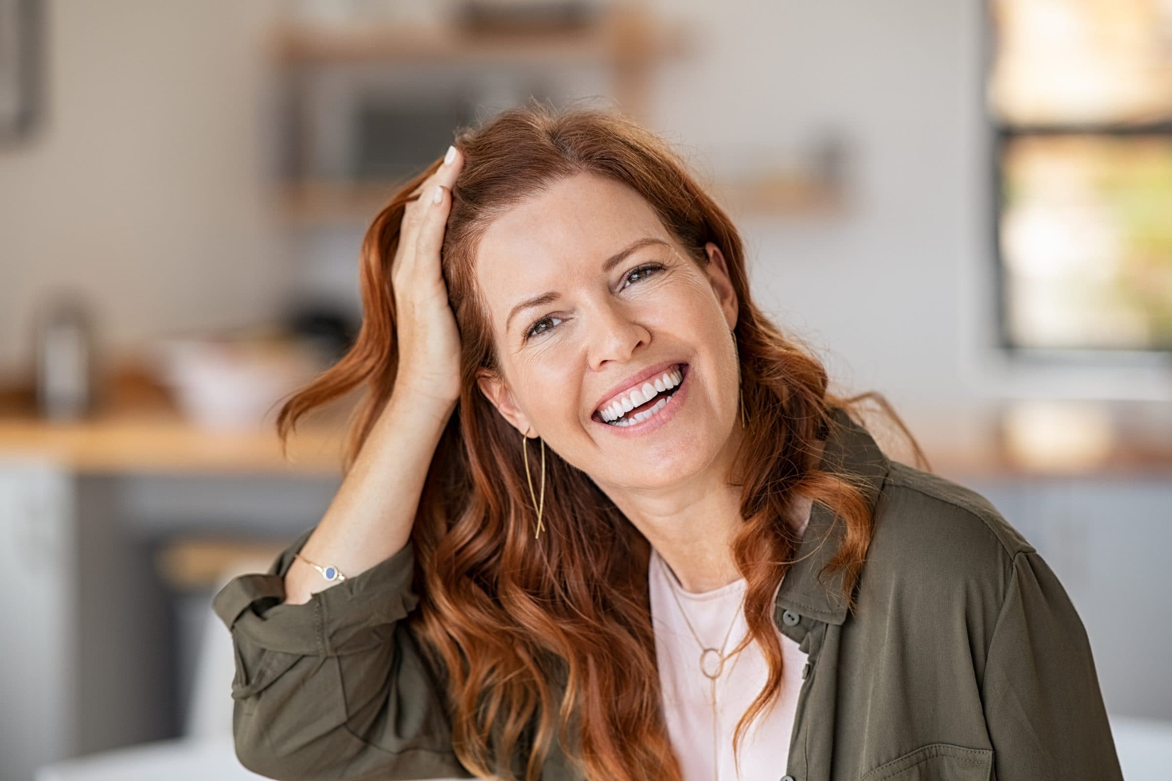 Woman showing off her teeth with dental implants